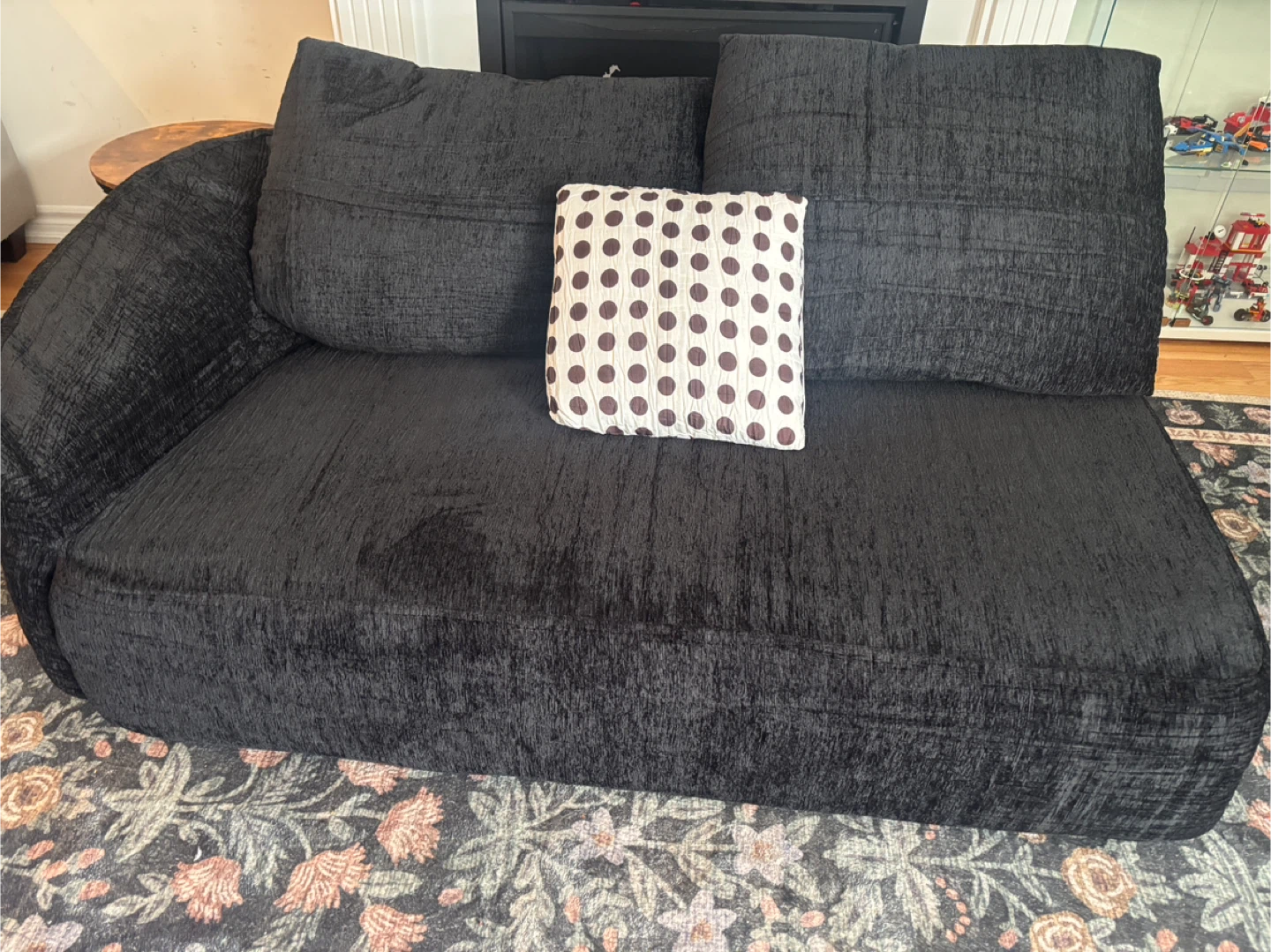 Black textured couch with  pillow