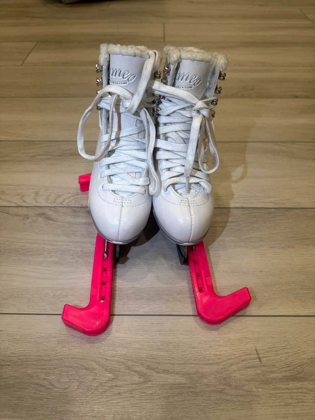 White Jackson Skates with Pink Blade Covers