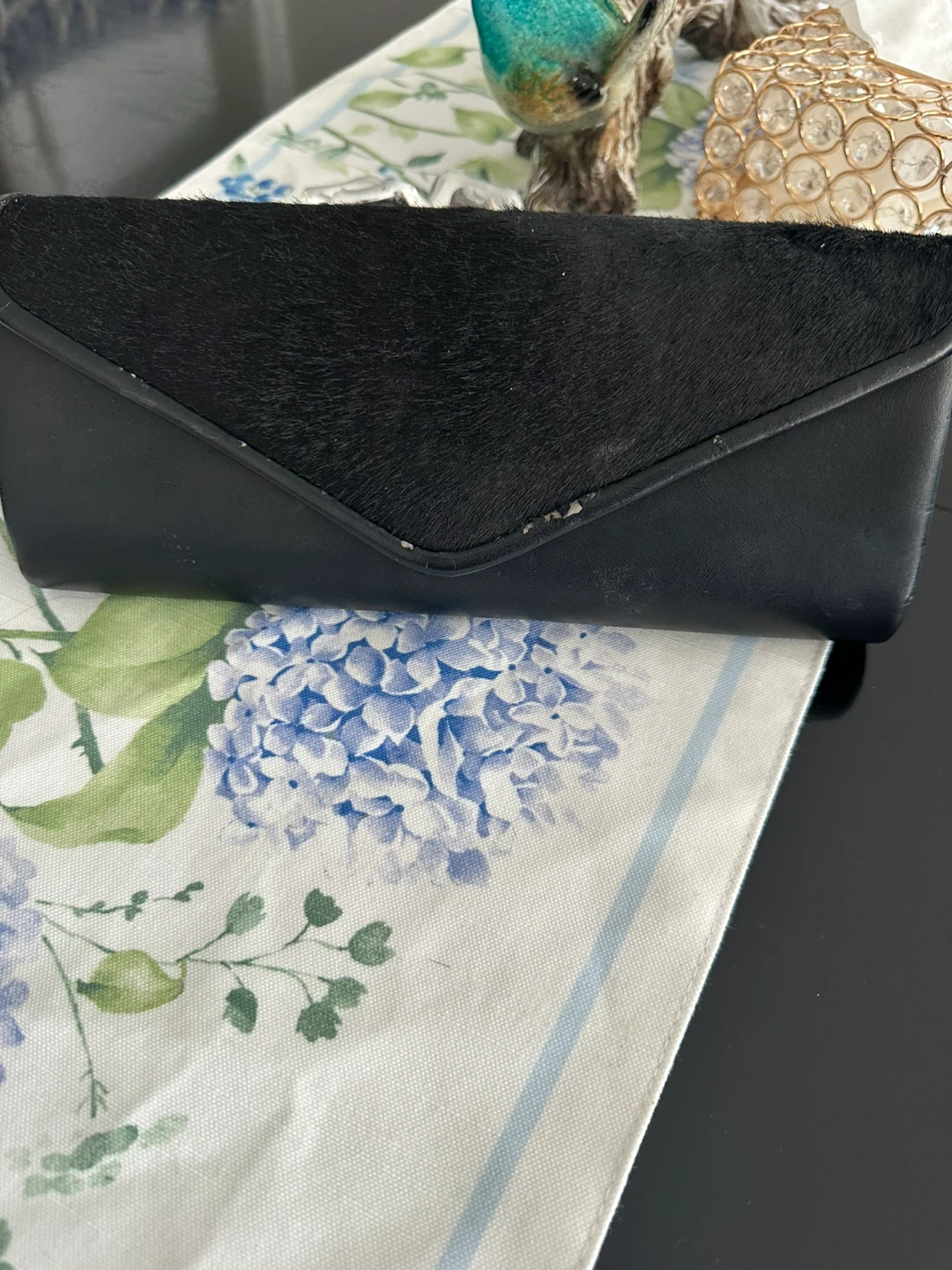 Black clutch with fur accent and chain strap