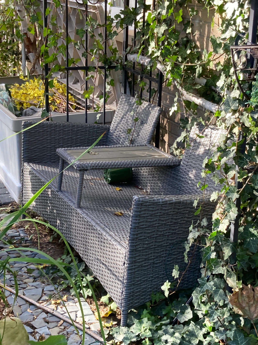 Wicker outdoor loveseat with built-in table