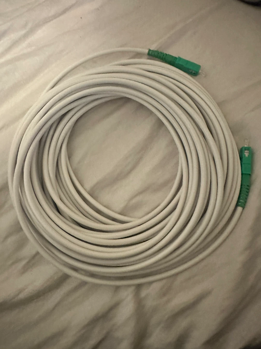 White Fibre Optic Cable with Green Connectors