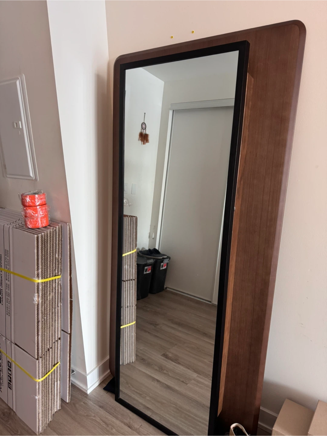 Full-length wood framed mirror