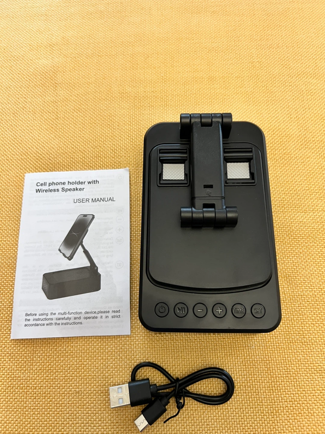 Cell phone holder with wireless speaker