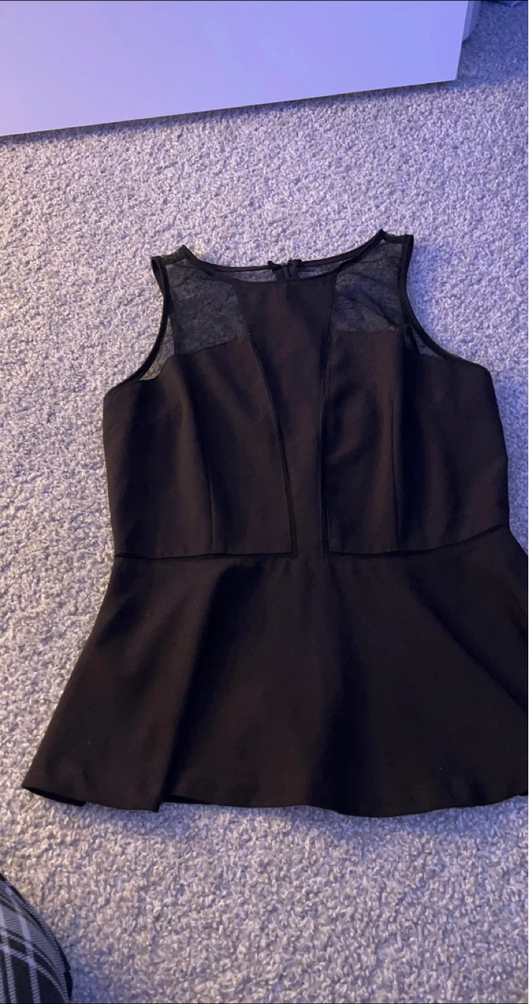 Black Sleeveless Peplum Top with Mesh Neckline