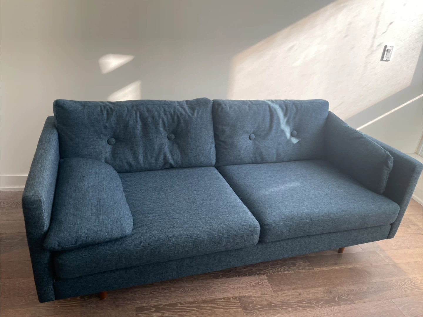 Article: Blue Sofa with Tufted Back Cushions