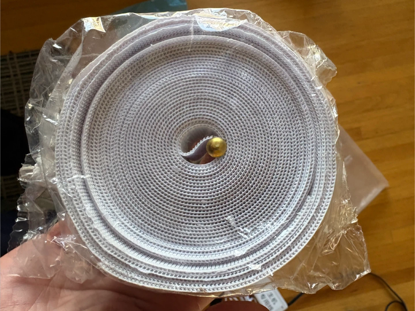 White Hook and Loop Fastener Roll with Brass Tacks