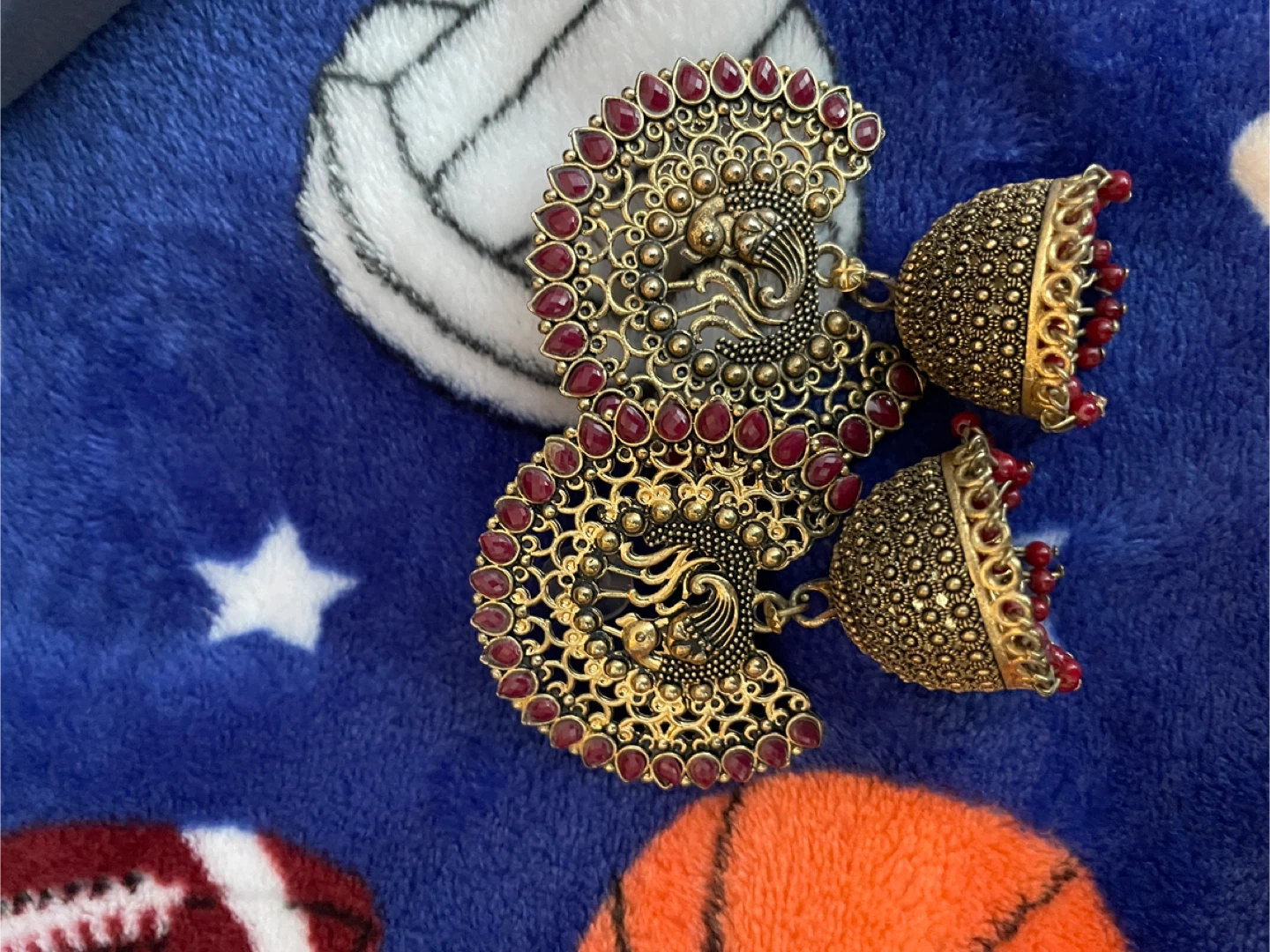 Gold Tone Peacock Jhumka Earrings with Red Stones
