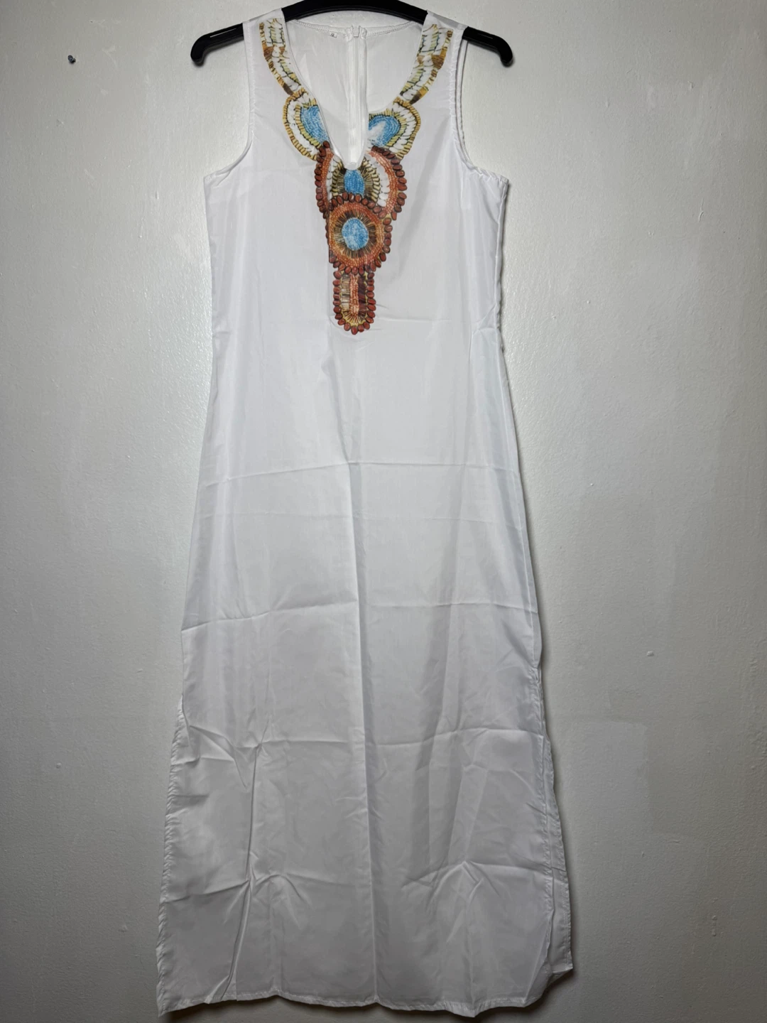 White sleeveless maxi dress with colorful embellished neckline