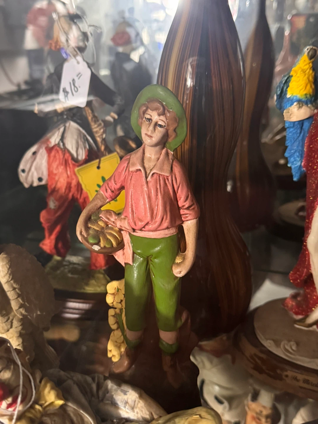 Figurine of a young boy with a basket of fruit