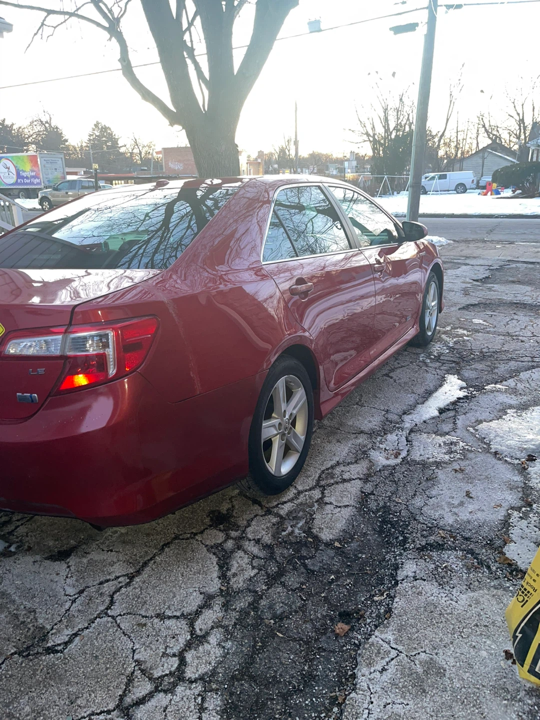 Red Toyota Camry Hybrid Sedan