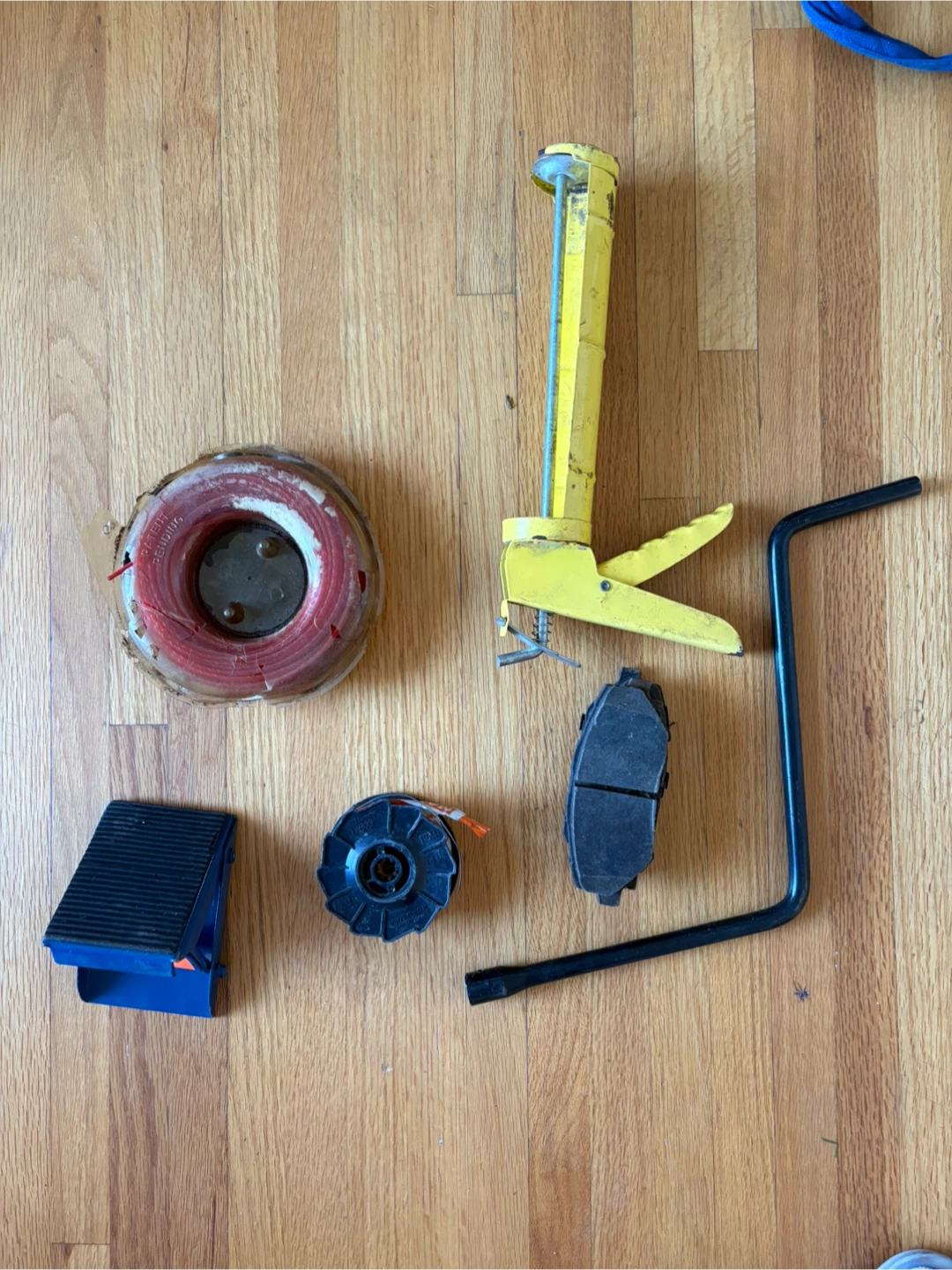 Yellow Caulking Gun and Tie Wire Spool