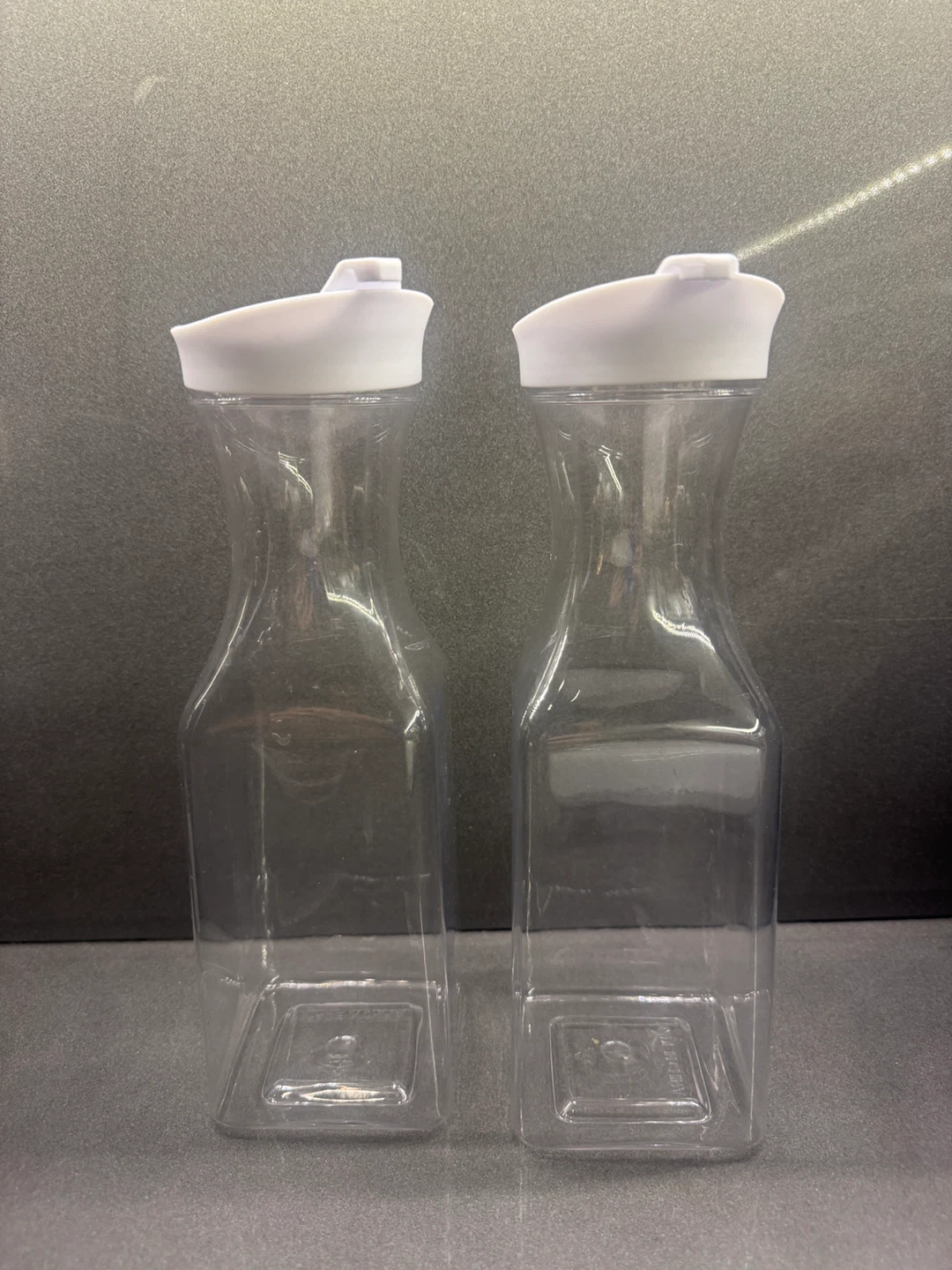 Set of 2 Clear Plastic Pitchers with White Lids
