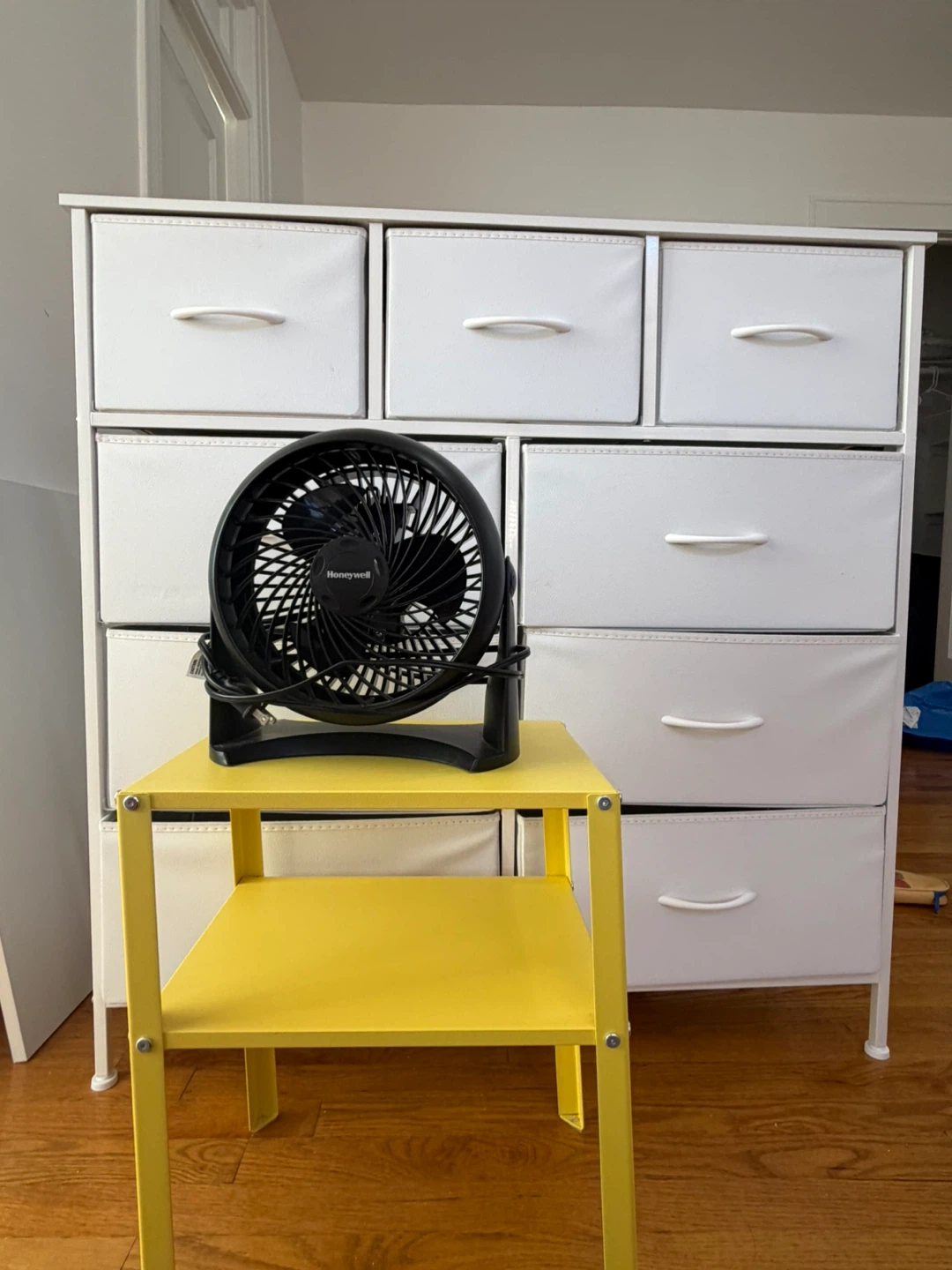 IKEA nightstand, a fan, and a chest of drawers