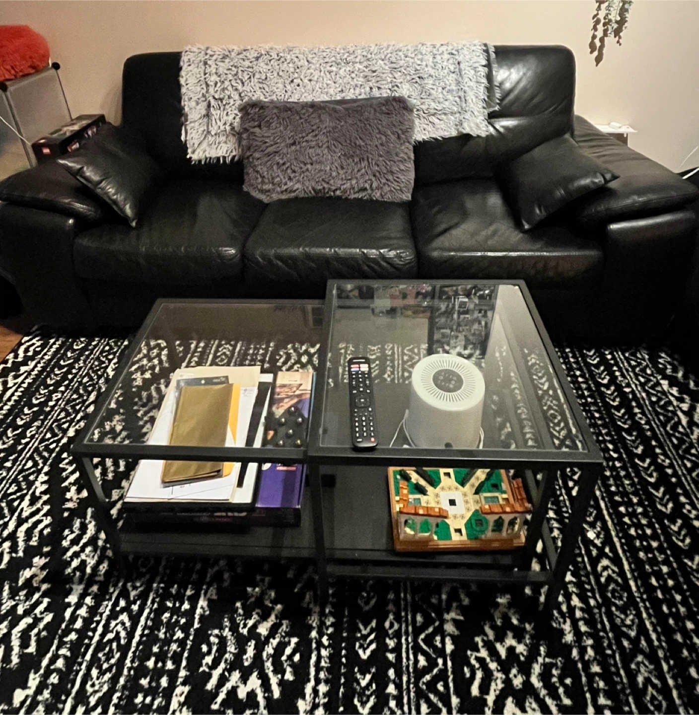 Black 3-Seater Leather Sofa with throw pillows and blanket