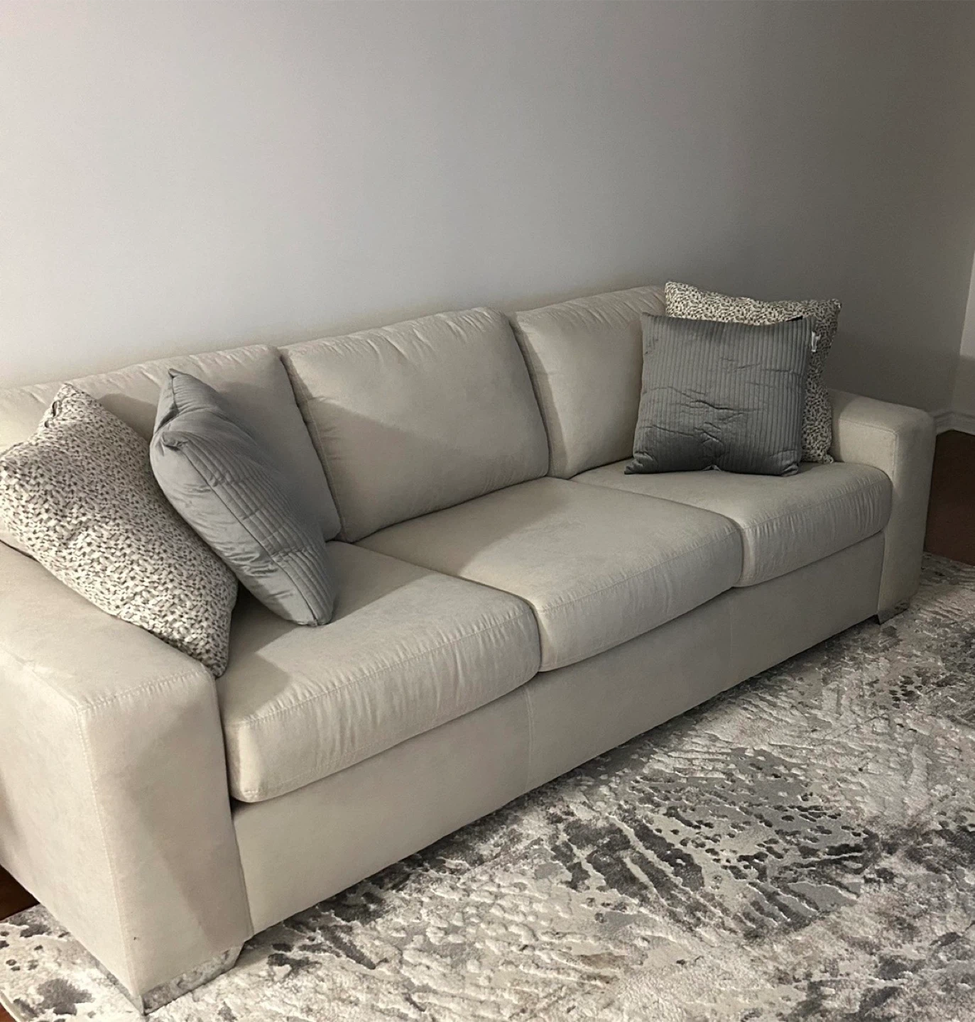 Light Beige Sectional Sofa with Pillows