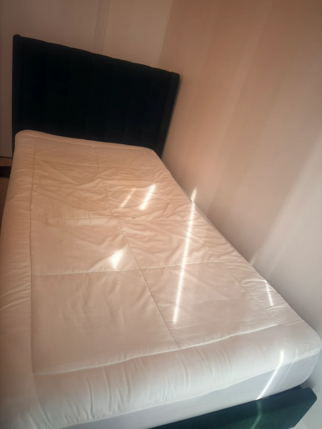 Twin bed frame with mattress and mattress pad
