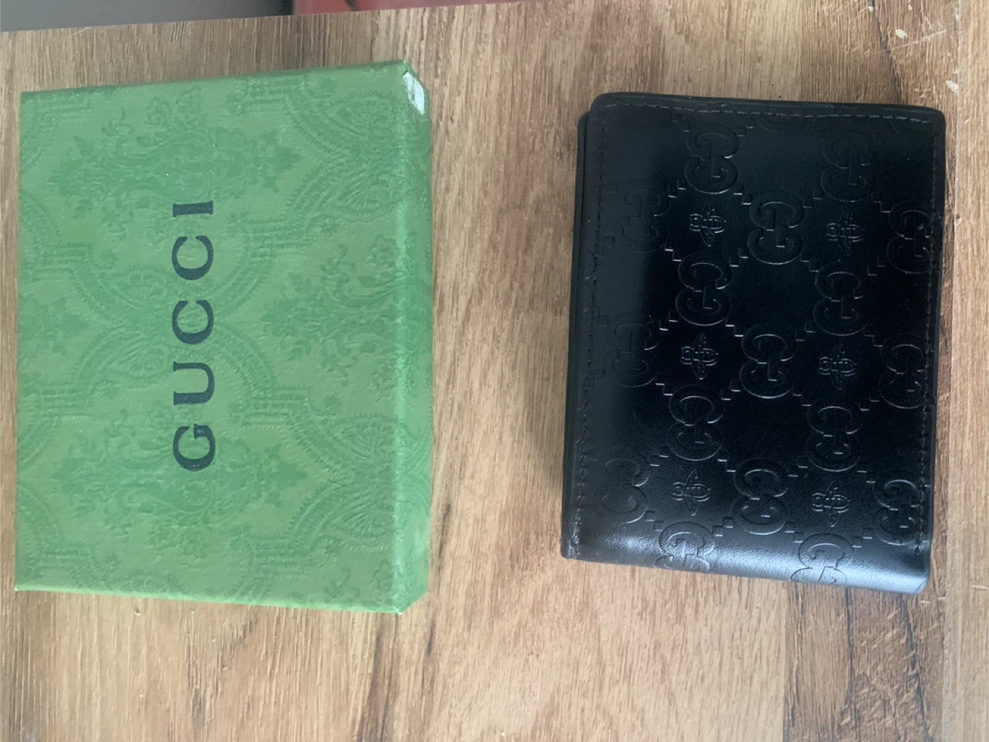 Black Gucci Embossed Bi-fold Wallet