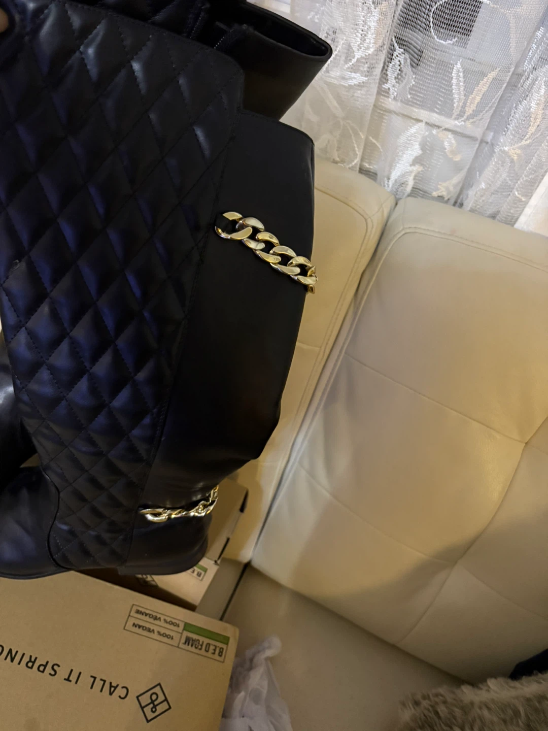 Black Quilted Knee-High Boots with Gold Chain Accent