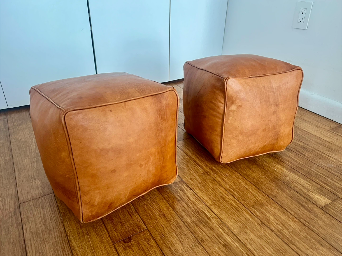Pair of tan leather pouf/ottoman/footstools - photo 2