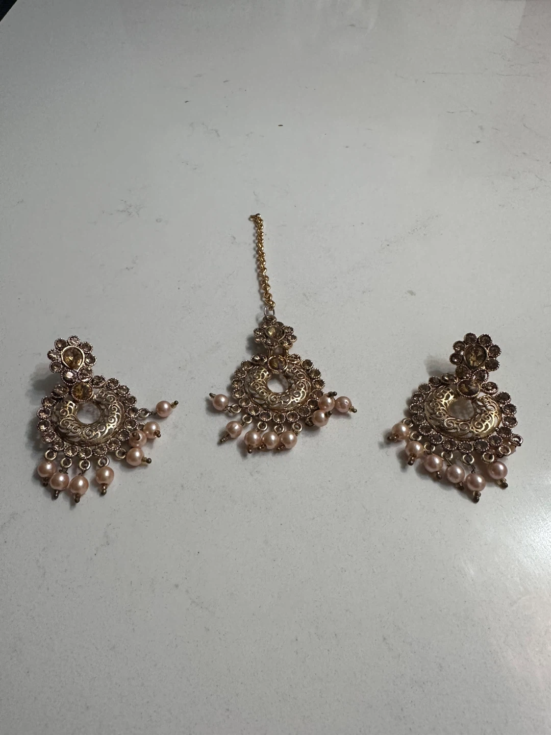 Gold Tone Jhumka Earrings and Tikka Set with Pink Pearls