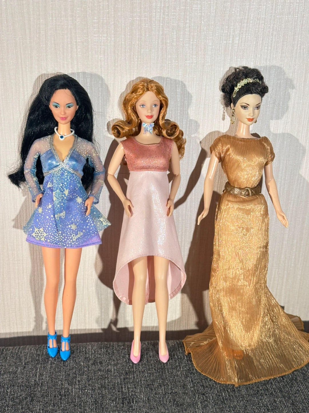 Three vintage Barbie fashion dolls in beautiful dresses