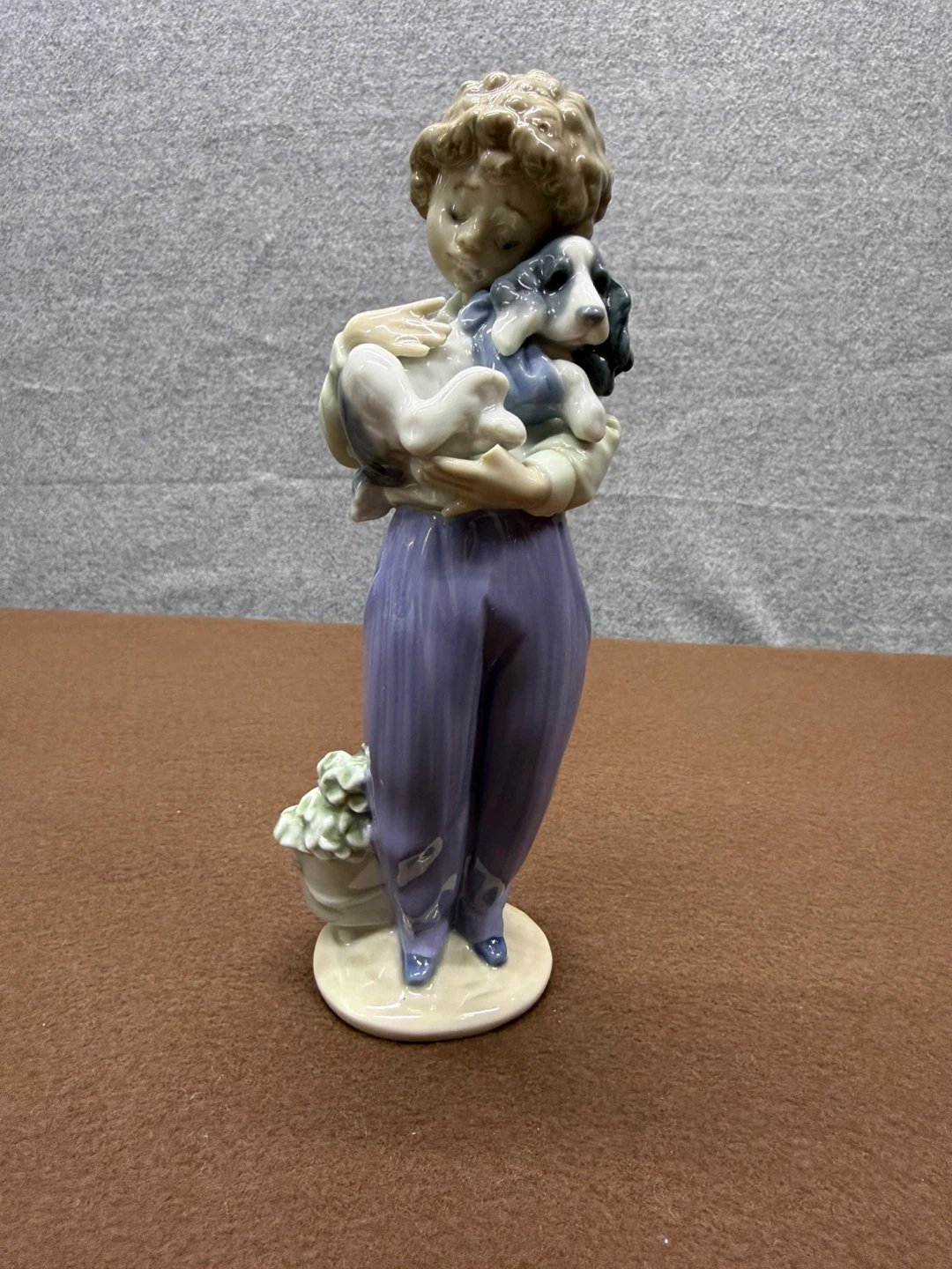 Porcelain Figurine of a Child Holding a Dog with Flowers