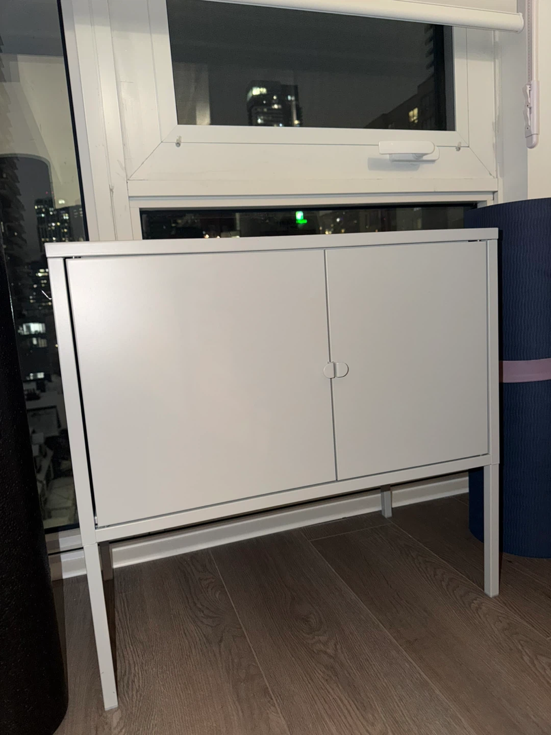 White two-door cabinet with legs