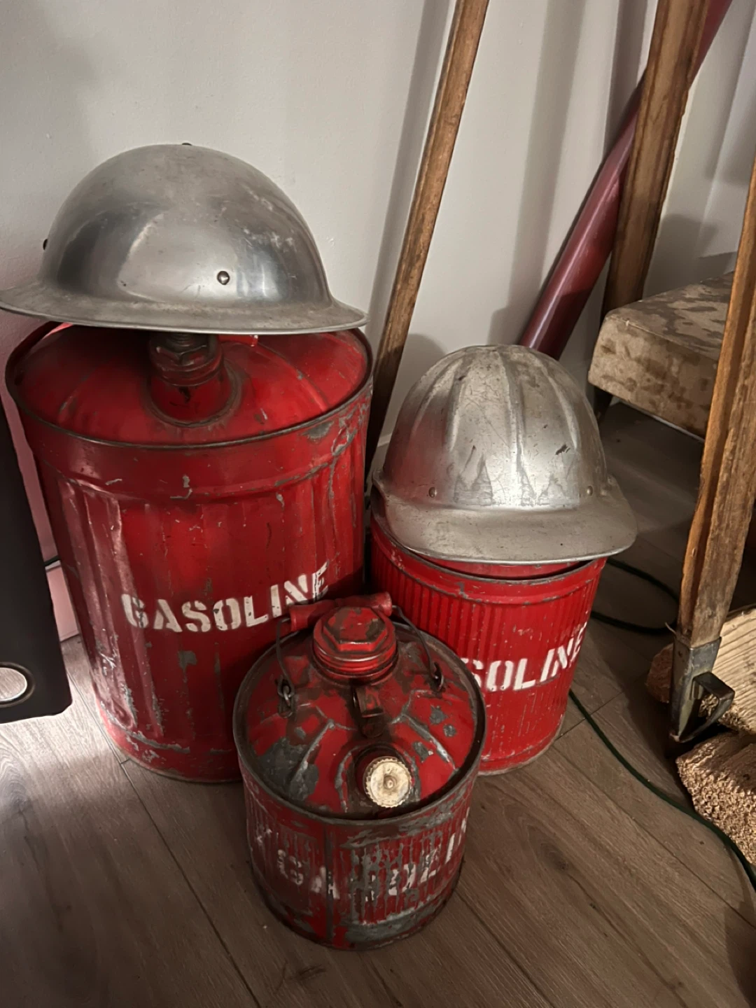 3 old gas cans. And two old hard hats.