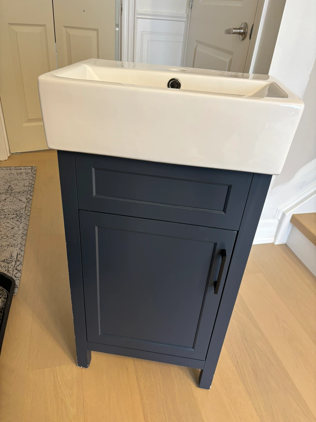 White Sink with Navy Blue Vanity Cabinet