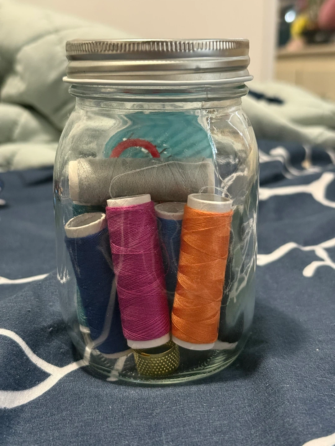 Sewing Thread Spools in Jar