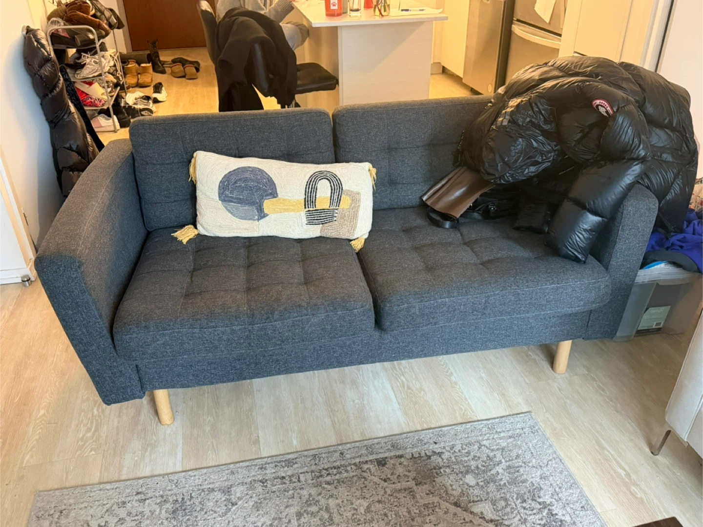 Grey Two-Seater Sofa with Decorative Pillow