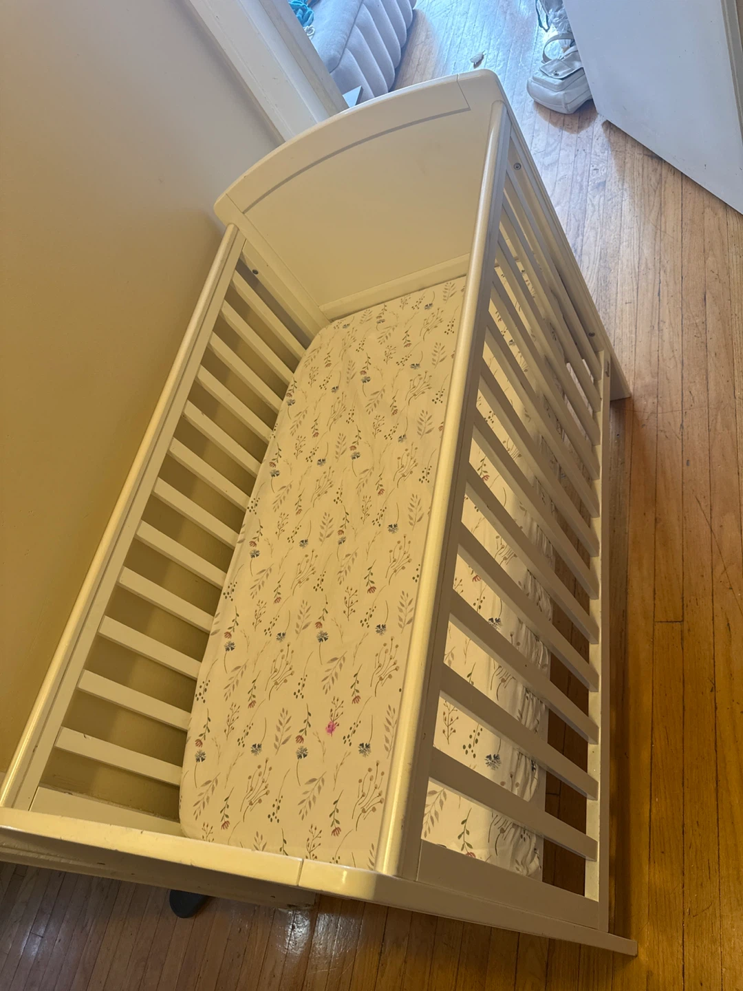 White Baby Crib with Floral Sheet