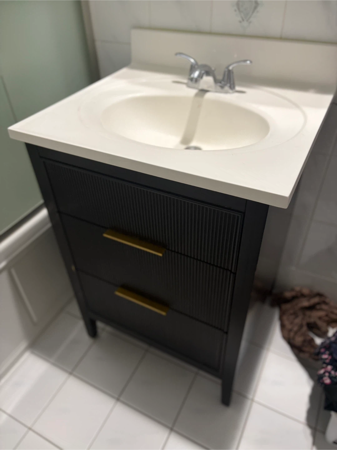 Black Vanity with Gold Drawer Pulls and Integrated Sink