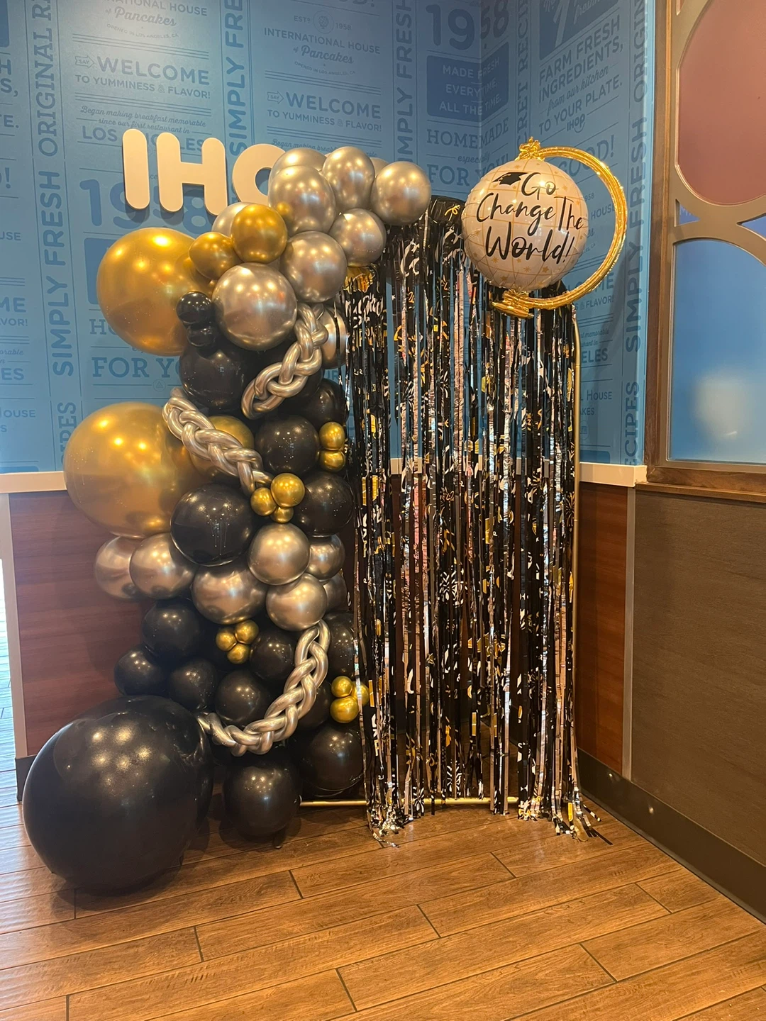 Gold, Silver, and Black Balloon Arch with Globe Decor