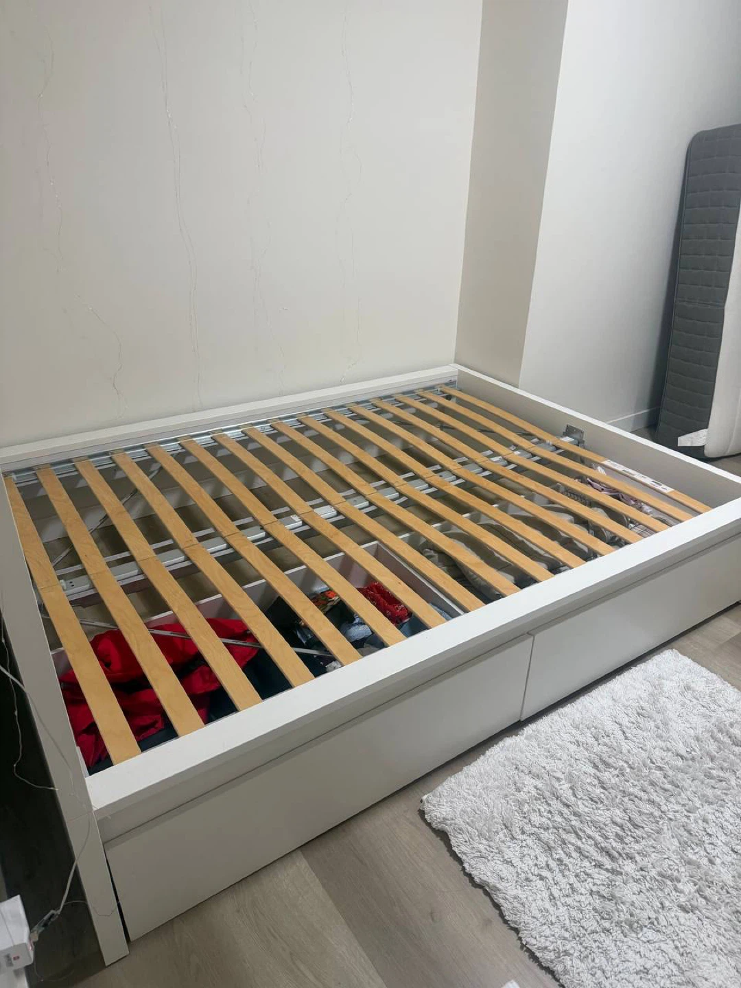 White bed with storage drawers and headboard