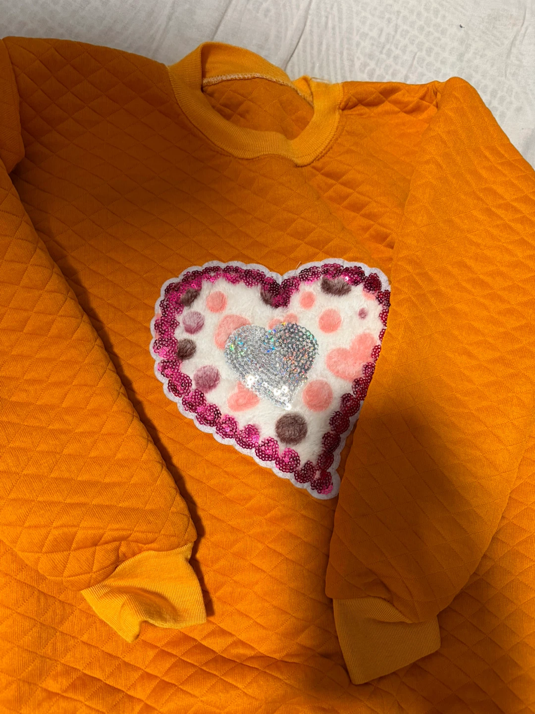 Orange Quilted Sweatshirt with Heart Embellishment
