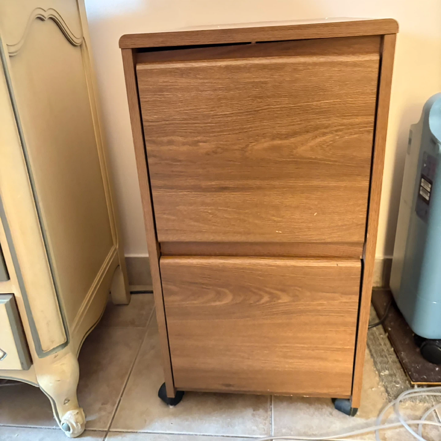 Brown wood filing cabinet on wheels