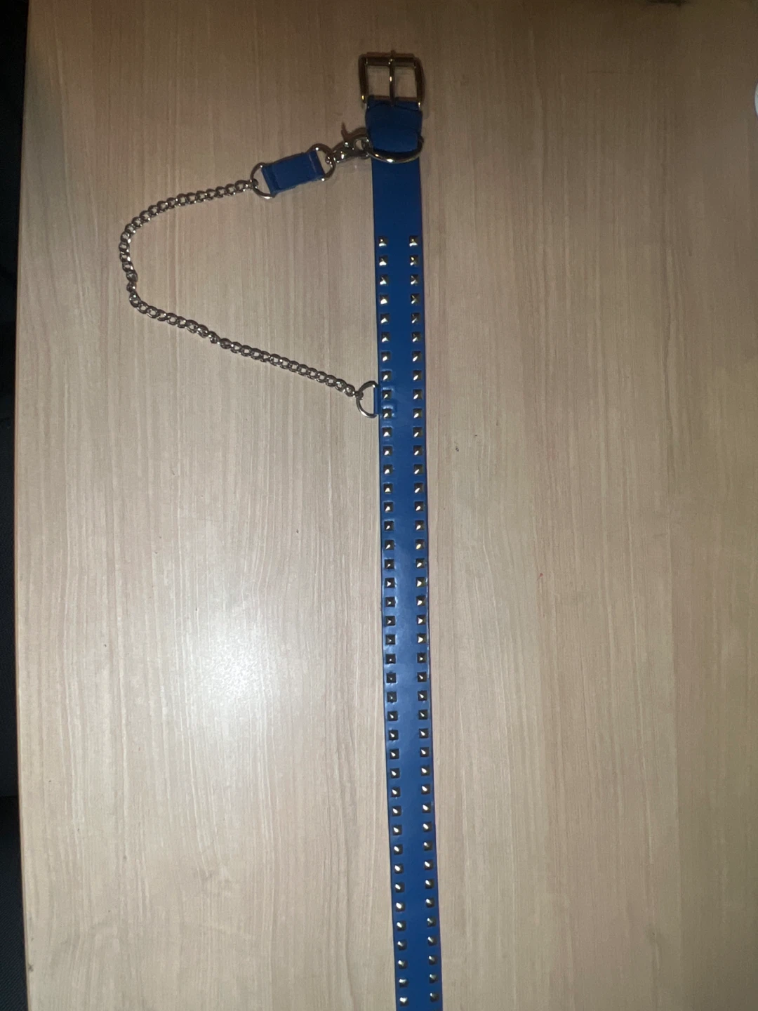 Blue studded belt with chain accent
