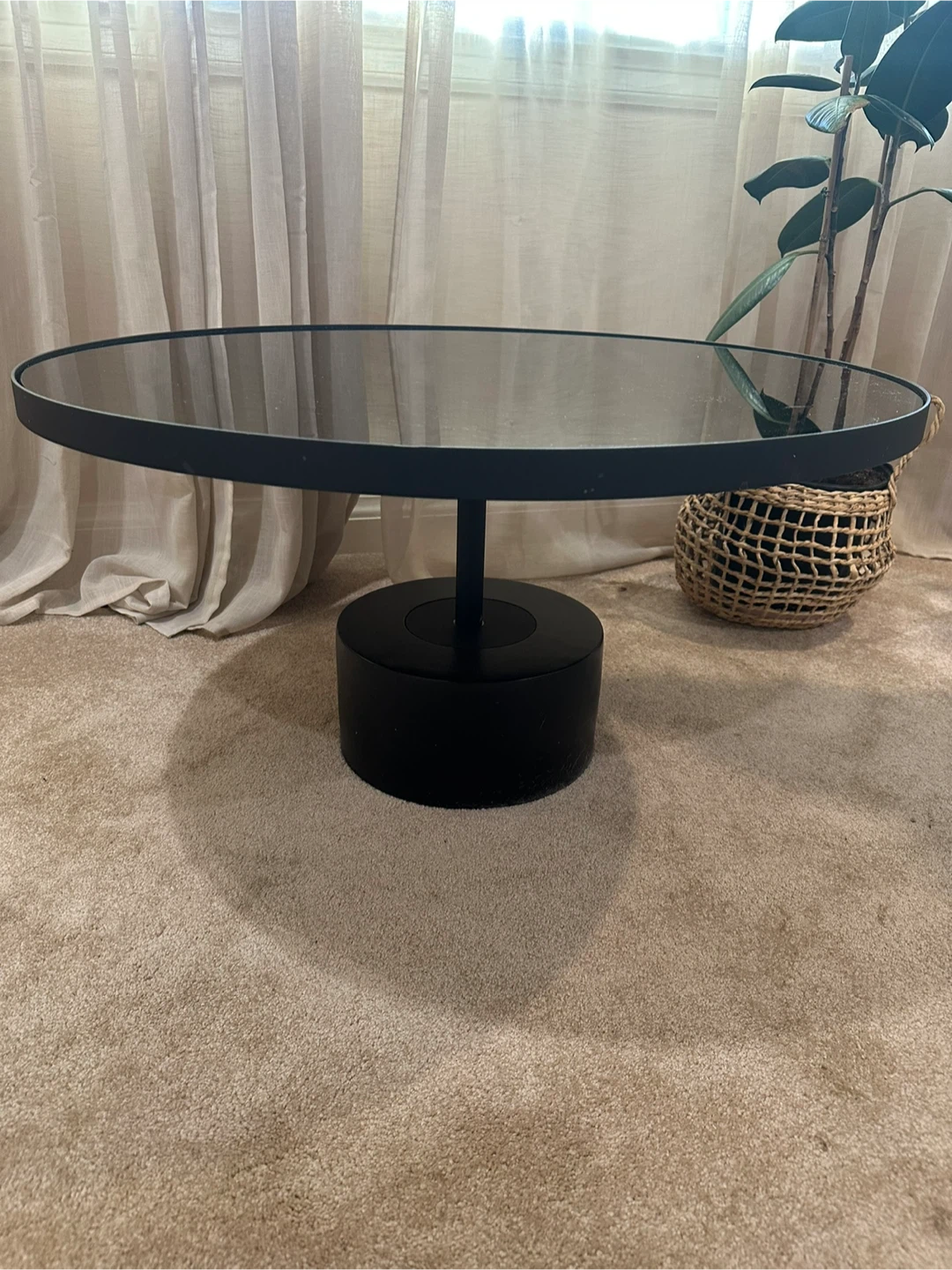 Coffee Table with black concrete base and tempered glass top.