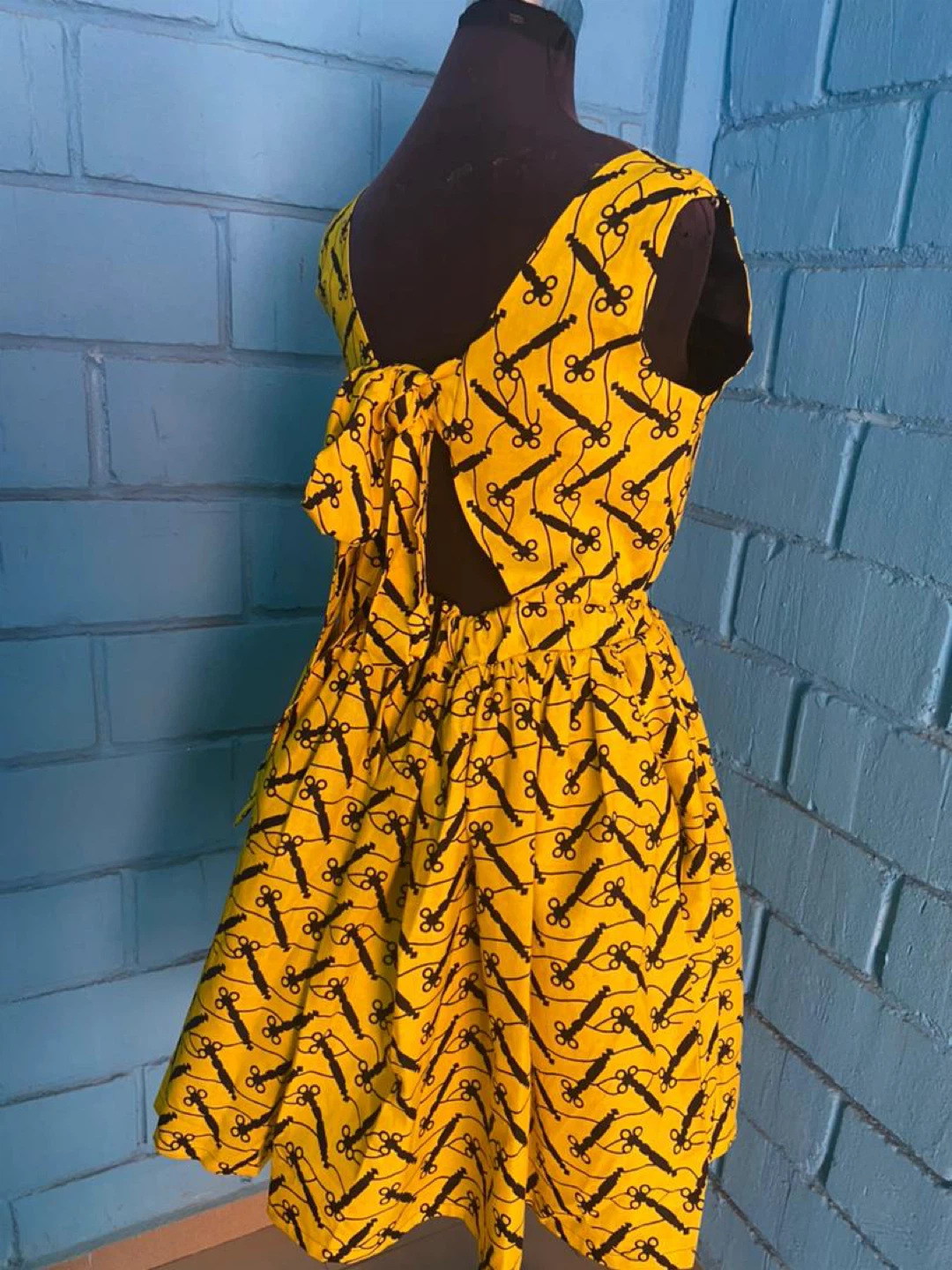 Yellow Sleeveless Dress with Black Pattern