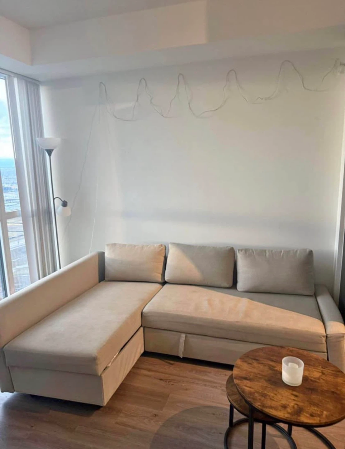 Beige Friheten style corner sofa-bed with storage