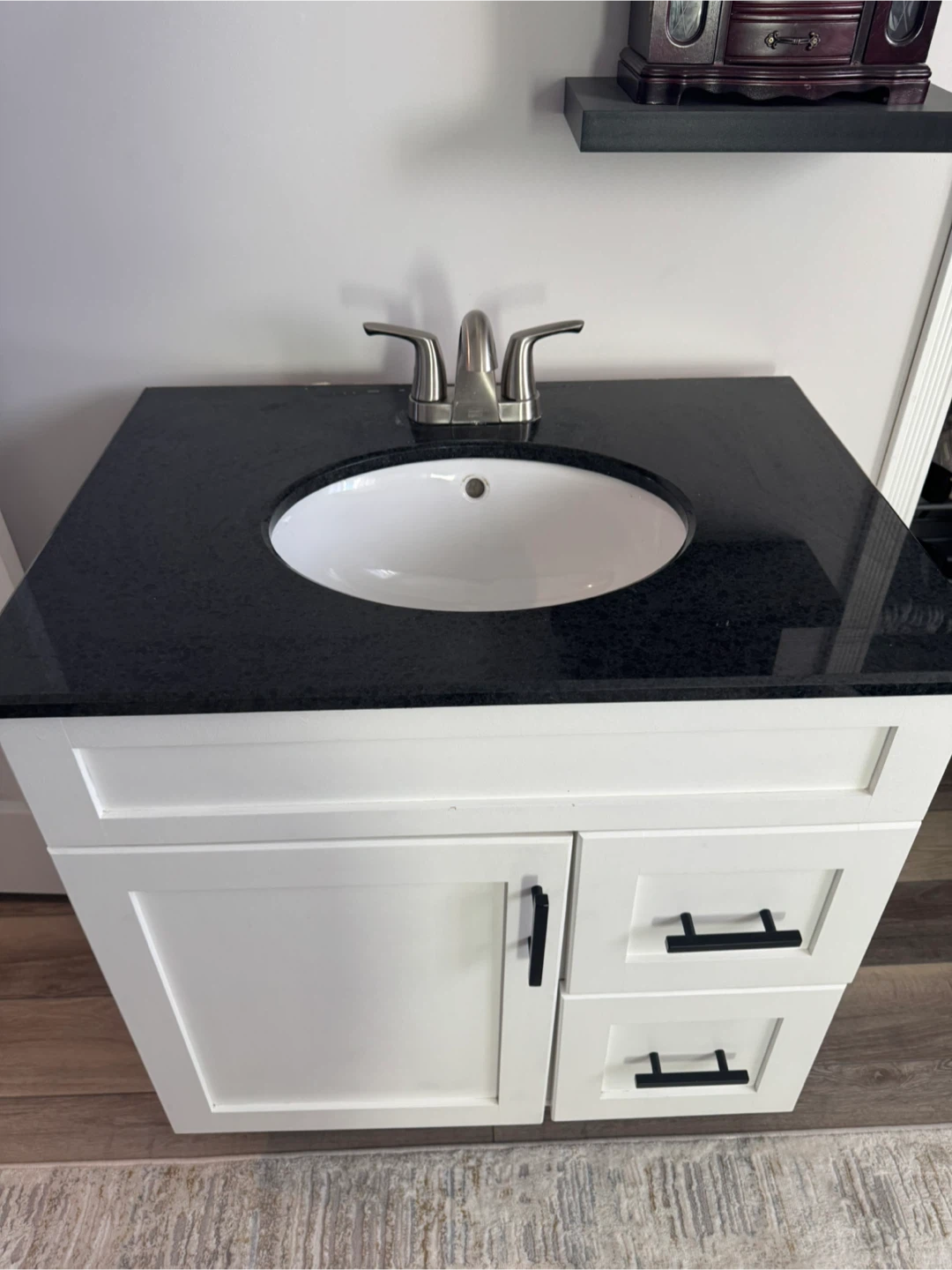 White Bathroom Vanity with Black Granite Top and Faucet