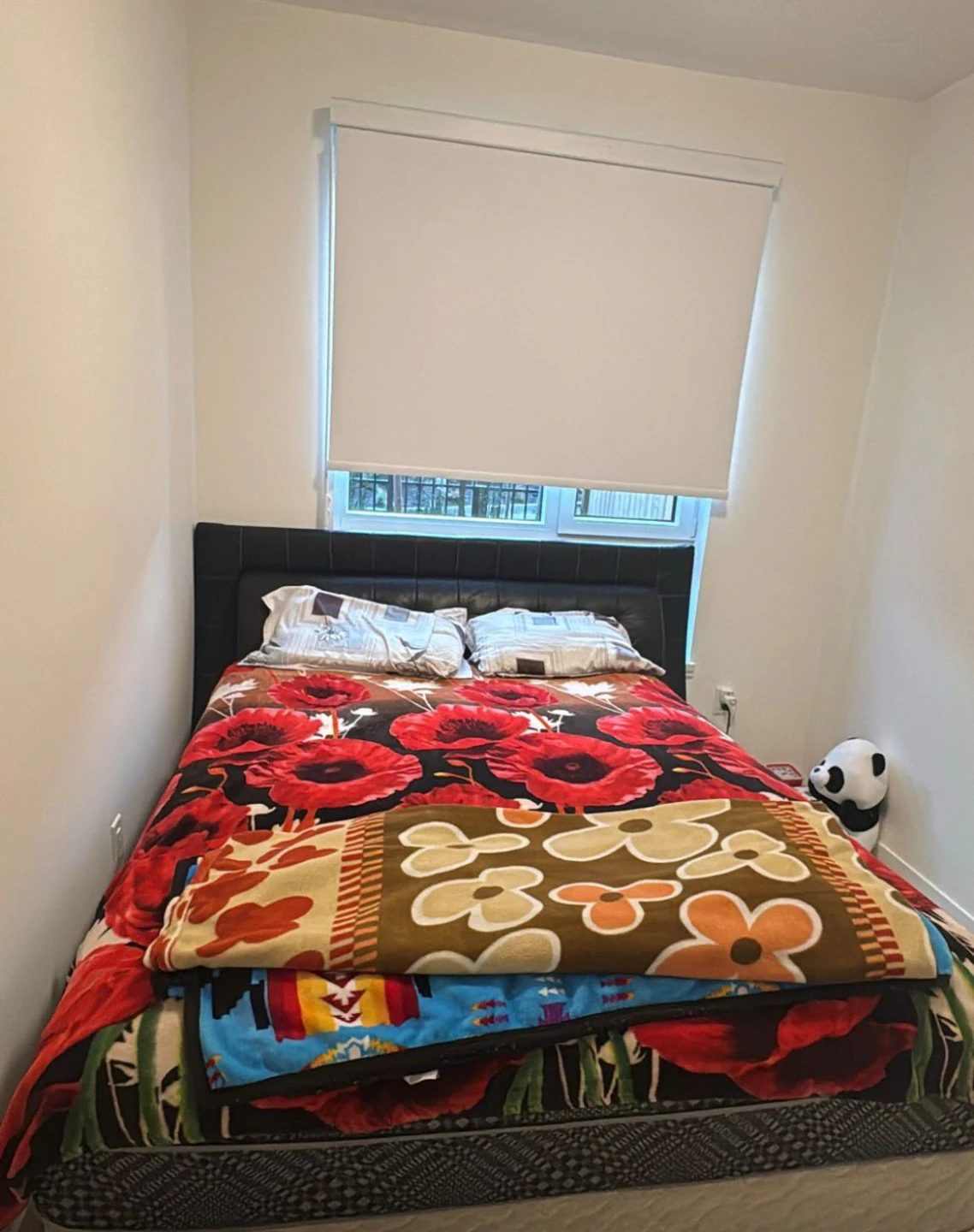Queen Size Bed with Black Faux Leather Headboard.