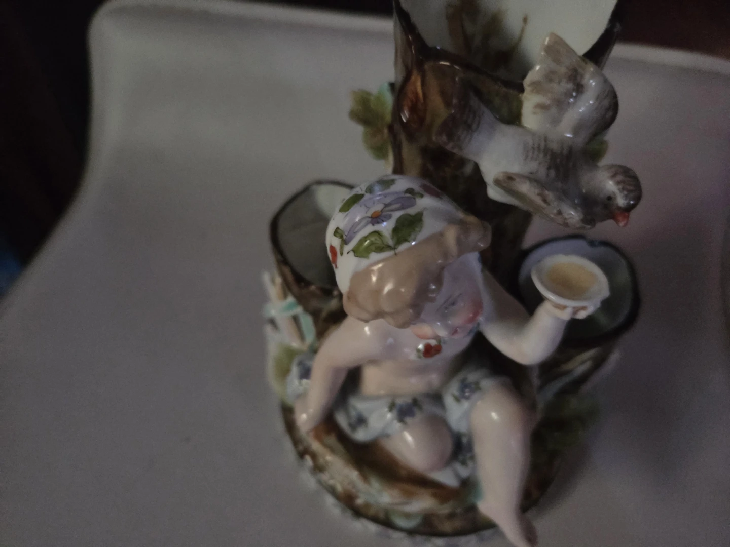 Porcelain Figurine of Cherub and Bird