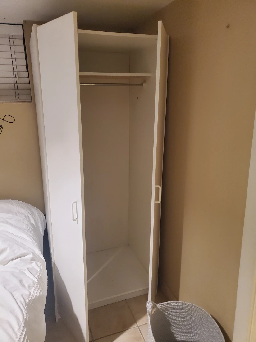 White wardrobe with hanging rail and shelf