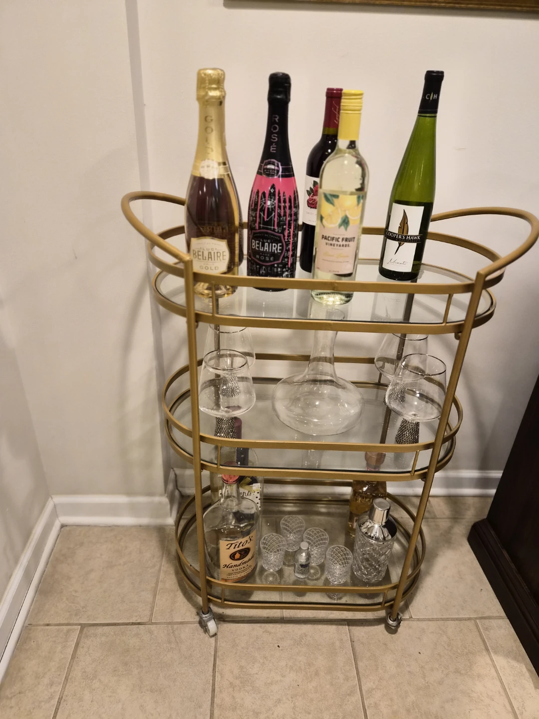 Gold Bar Cart with Assorted Drinks and Glasses