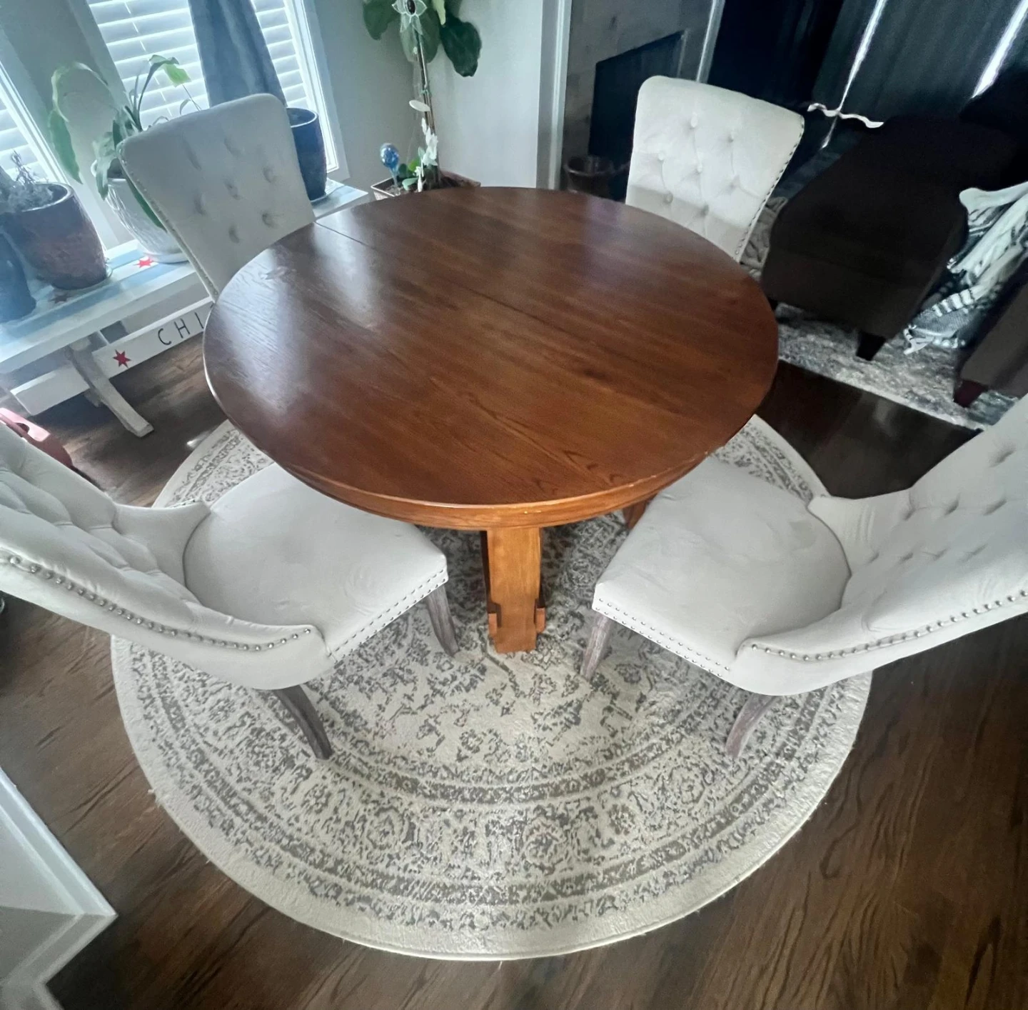 Round Drop Leaf Dining Table with 4 Chairs and rug.