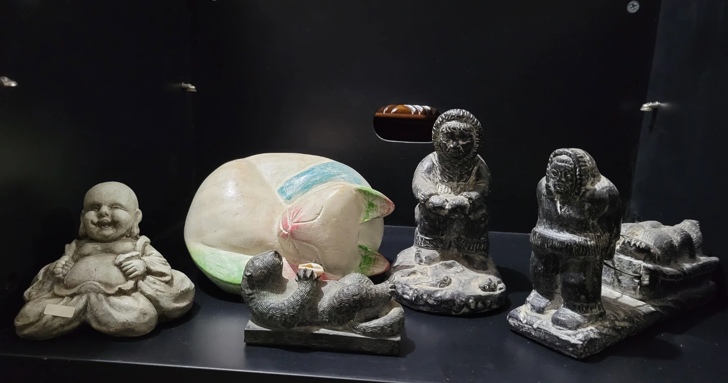 Stone Carvings: Buddha, Cat, Otter, and Inuit Figures