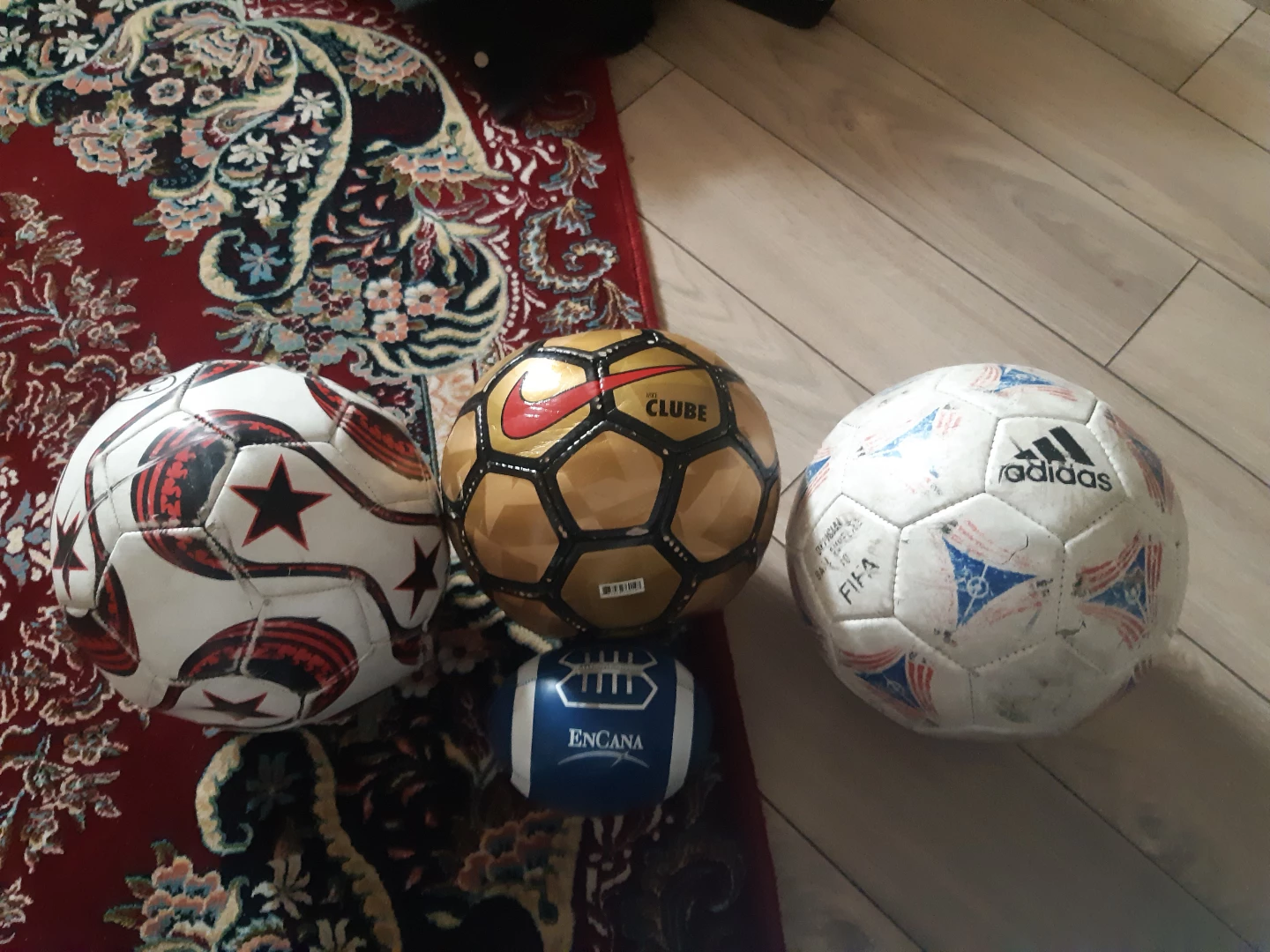 Soccer balls and a small American football.