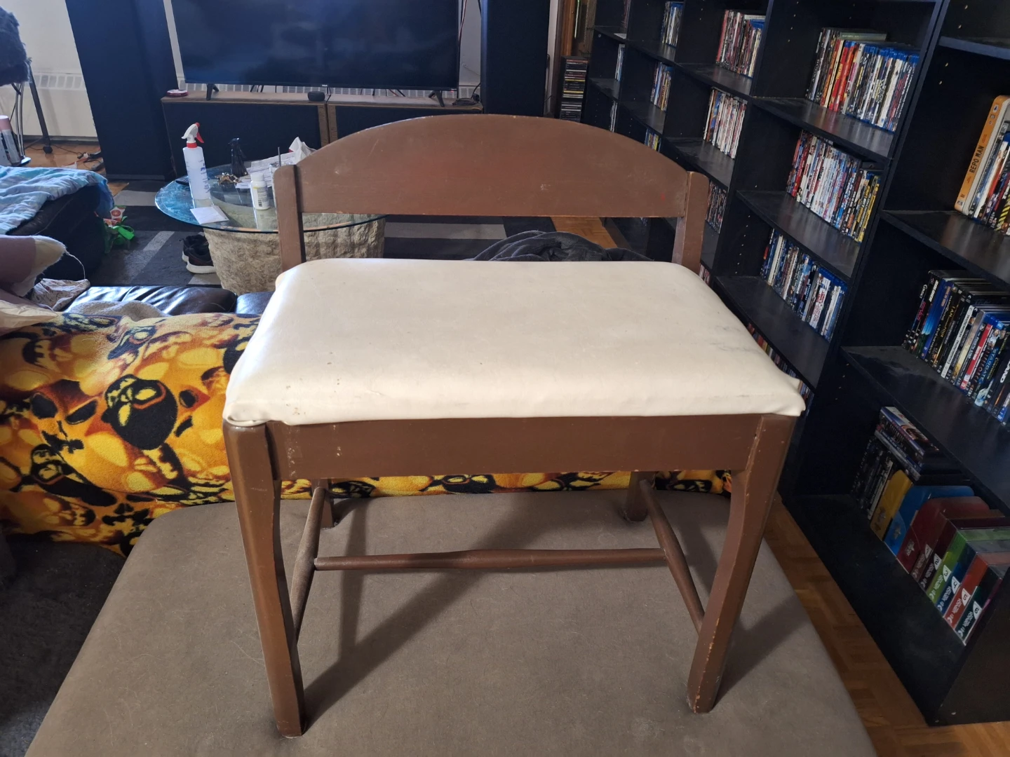 Small brown bench, with white Leather seat. Very cute.